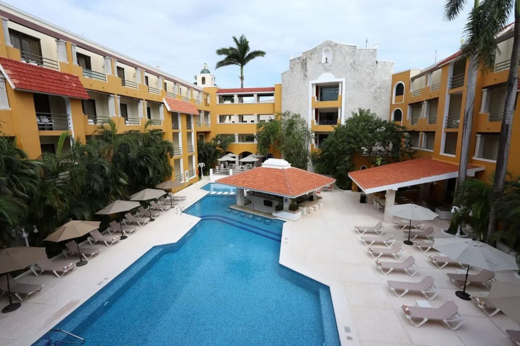 Courtyard pool with sun loungers at Adhara Hacienda Cancun in Cancún, Mexico.