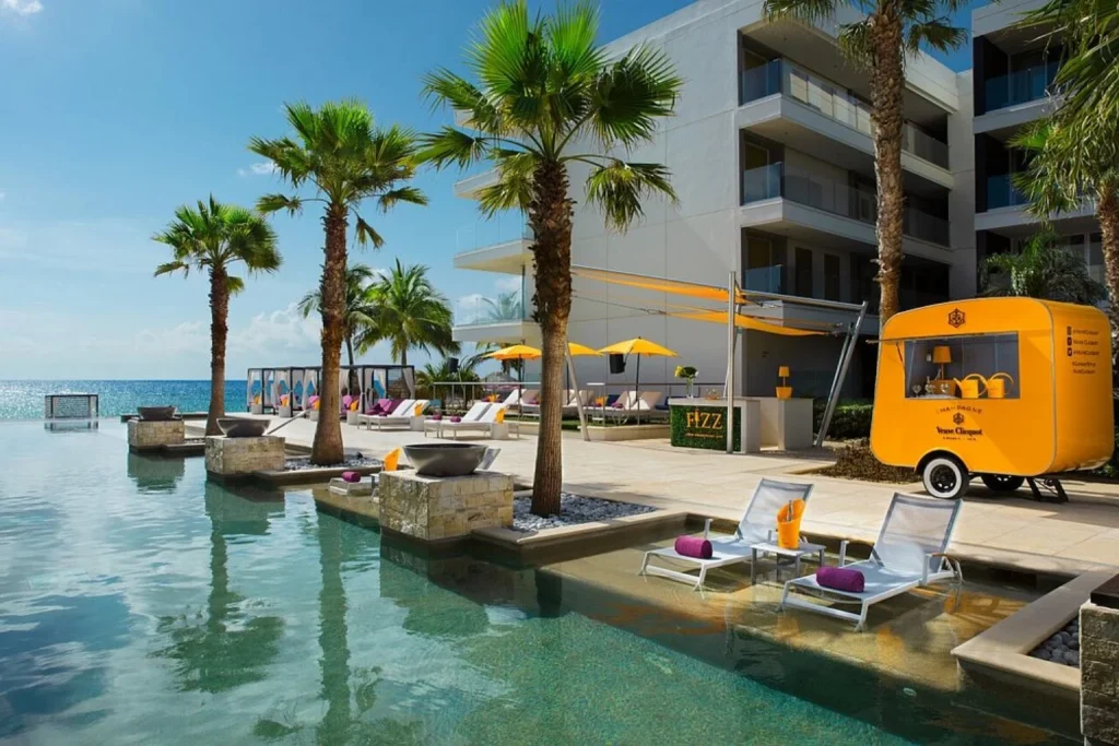 Infinity pool with palm trees and ocean view at Breathless Riviera Cancun