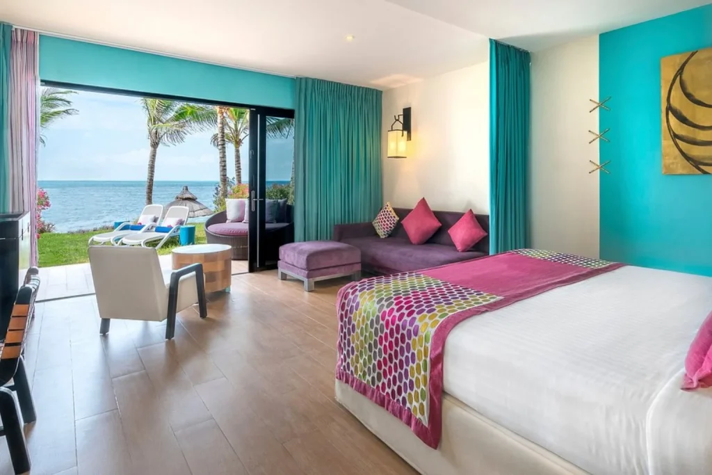 Oceanfront room with king bed and sitting area overlooking the Caribbean Sea at Club Med Cancun