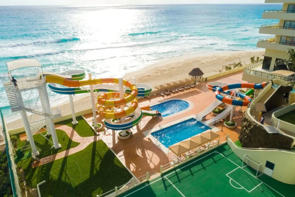 Water slides and pools by the beach at Crown Paradise Club Cancun in Cancun, Mexico