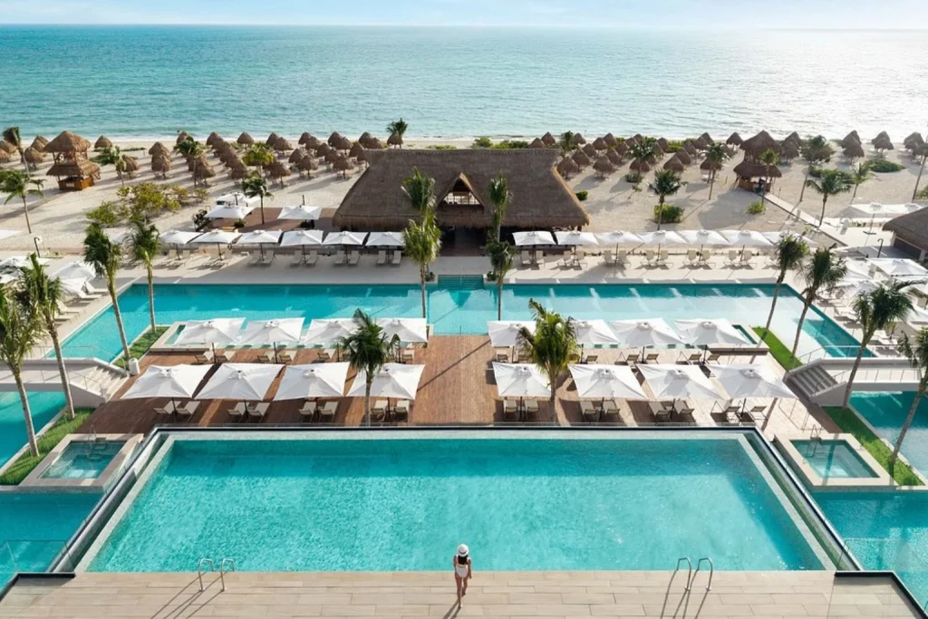 Beachfront swimming pools and Caribbean Sea at Excellence Playa Mujeres Cancun