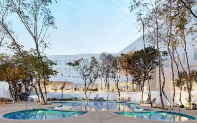 Outdoor pool at dusk at Fairfield Inn & Suites by Marriott Cancun Airport in Cancún, Mexico.