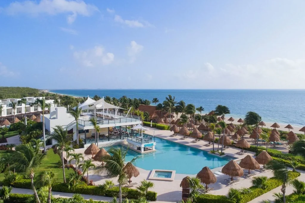 Heated oceanfront infinity pool with a swim-up bar overlooking the Caribbean Sea at Finest Playa Mujeres in Playa Mujeres, Mexico.