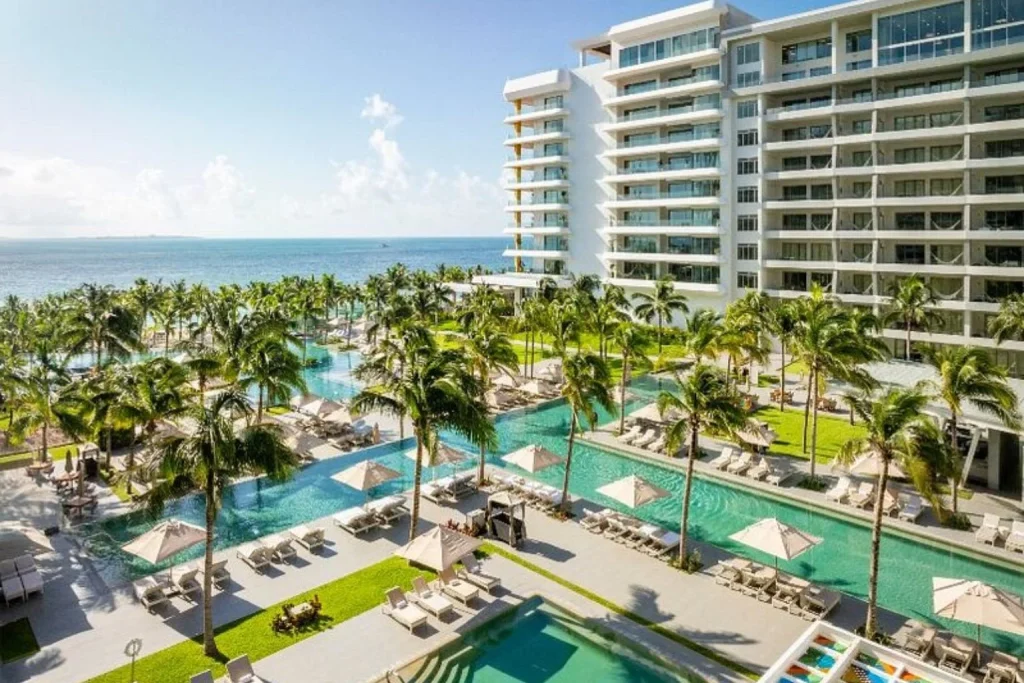 Heated oceanfront infinity pool complex with tropical gardens at Garza Blanca Cancun in Costa Mujeres, Mexico.