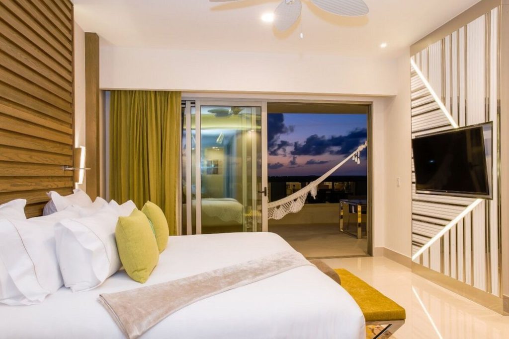 Modern ocean view suite with a private balcony and hammock at Garza Blanca Resort & Spa Cancun in Cancun, Mexico.