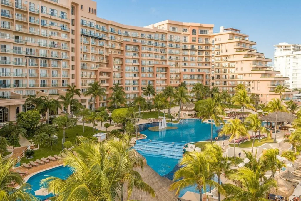 Lagoon-style outdoor swimming pools surrounded by tropical gardens at Grand Fiesta Americana Coral Beach Cancun in Cancún, Mexico.