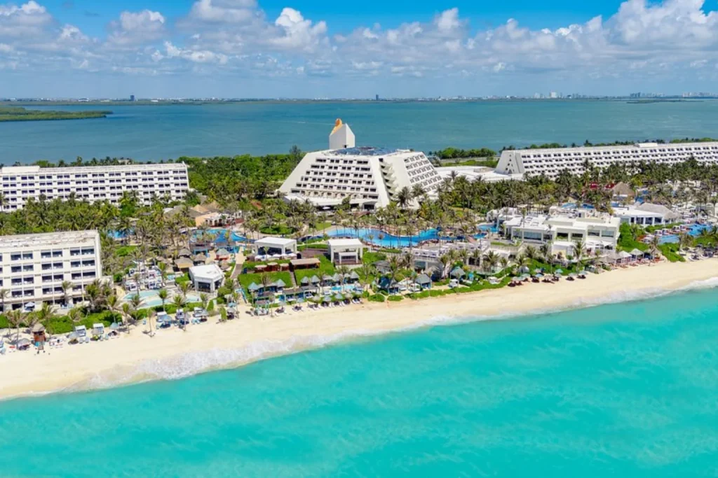 Aerial view of Grand Oasis Cancun with beachfront resort buildings, pools and turquoise Caribbean Sea