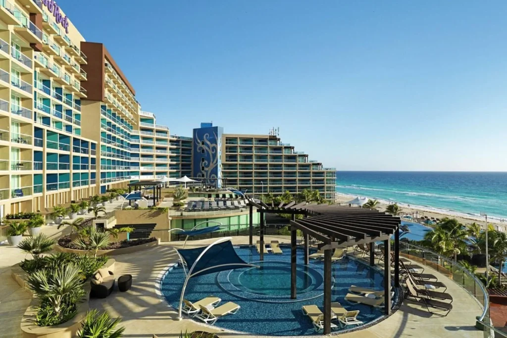 Breeze Terrace Pool with ocean views, sun loungers, and shaded seating at Hard Rock Hotel Cancun in Cancún, Mexico.