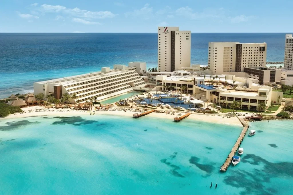 Beachfront resort with swimming pools, sandy beach and turquoise Caribbean waters at Hyatt Ziva Cancun in Cancun.