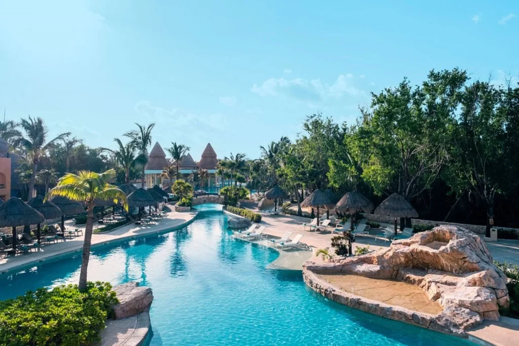 Pool with tropical landscaping at Iberostar Selection Paraiso Maya Suites in Riviera Maya, Mexico