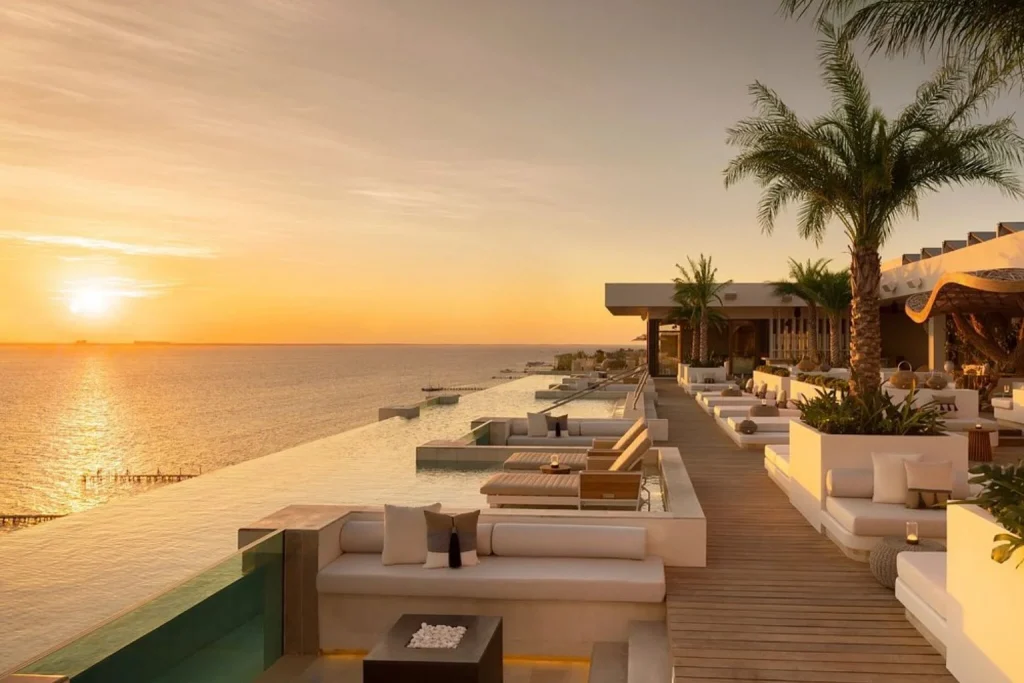 Rooftop infinity pool at sunset at Impression Isla Mujeres by Secrets overlooking the Caribbean Sea near Cancun
