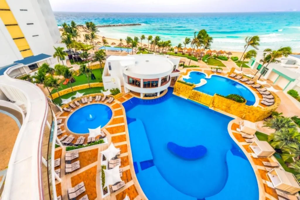 Aerial view of the oceanfront swimming pool complex overlooking the Caribbean Sea at Krystal Grand Cancun in Cancún, Mexico.