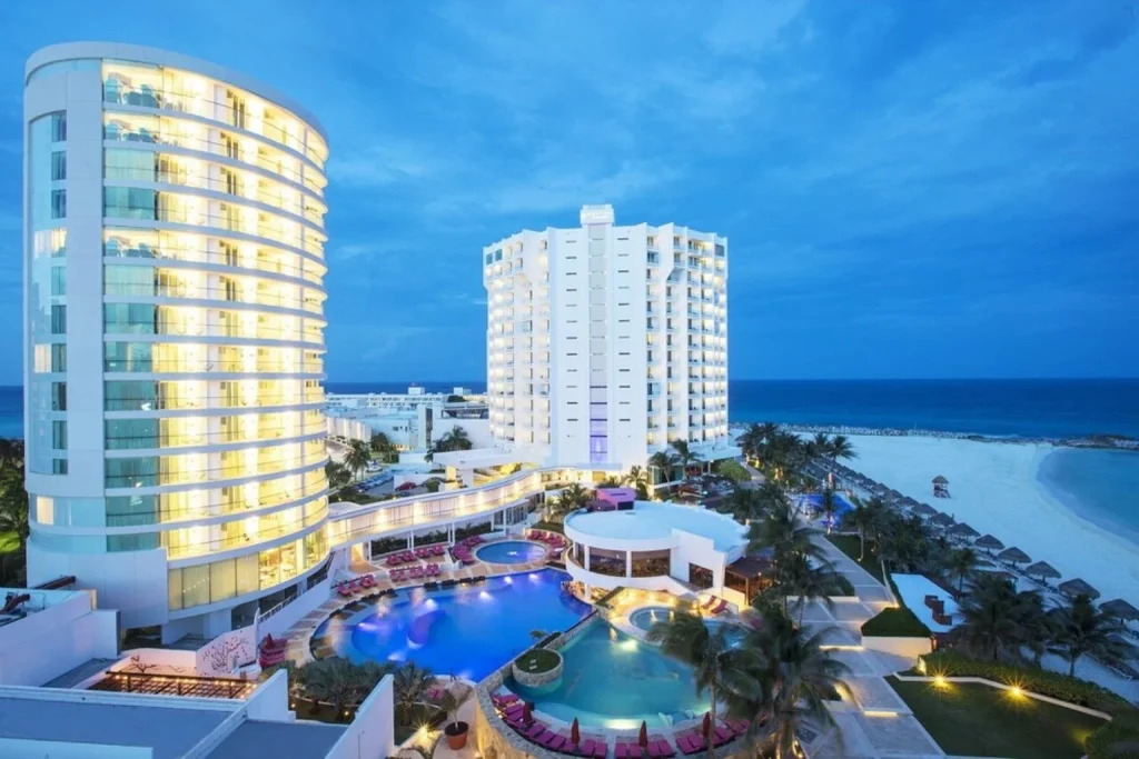 Resort pools and beachfront at Krystal Grand Cancun in Cancun at dusk
