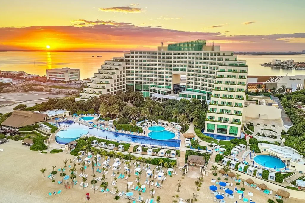 Aerial view of Live Aqua Beach Resort Cancun with pools and beachfront at sunset