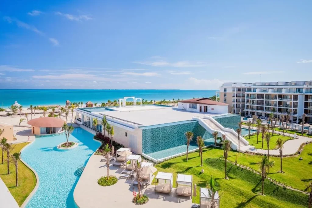 Oceanfront pool and modern resort buildings overlooking the Caribbean Sea at Majestic Mirage Costa Mujeres in Costa Mujeres.