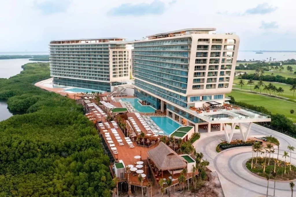 Aerial view of the resort with outdoor pools, tropical surroundings and nearby golf course, Mondrian Cancun, Cancun