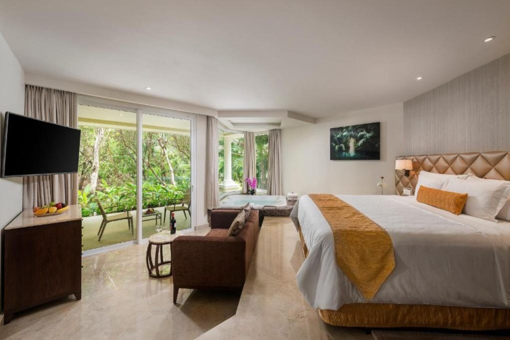 Spacious garden view suite with an indoor jacuzzi and private terrace at Moon Palace Cancun in Cancun, Mexico.