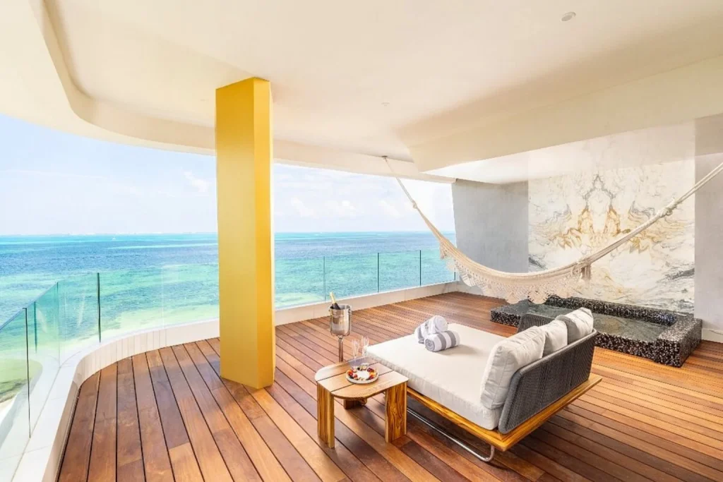 Ocean-view terrace with hammock and lounge bed at Mousai Cancun