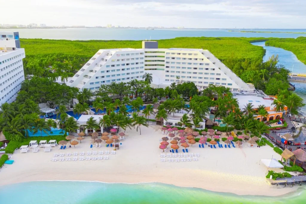 Aerial view of the beach and resort buildings at Oasis Palm and Grand Oasis Palm in Cancun