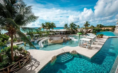 Family pool with slides and cabanas at Palmaïa – The House of AïA in Playa del Carmen, Riviera Maya, Mexico.