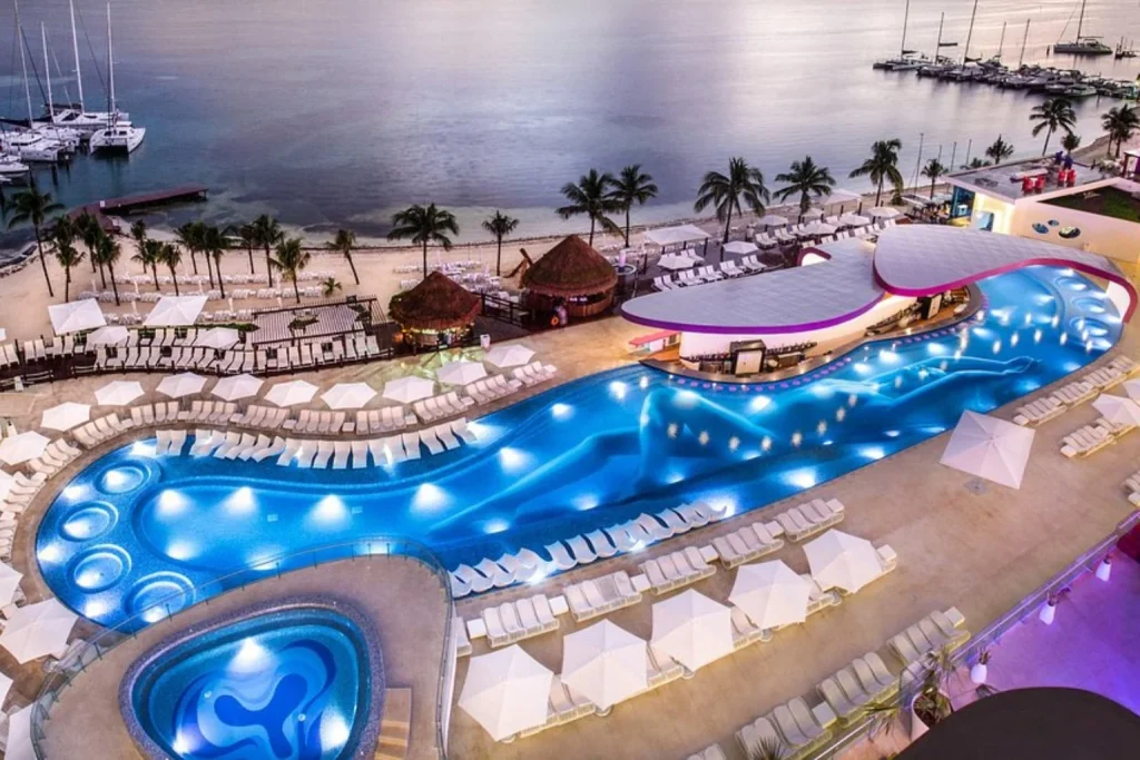 Large illuminated outdoor pool beside the beach and marina, Temptation Cancun Resort, Cancun