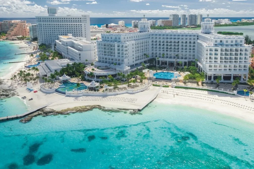 Aerial view of Riu Palace Las Américas in Cancun, showing the beachfront resort, swimming pools and Caribbean Sea.