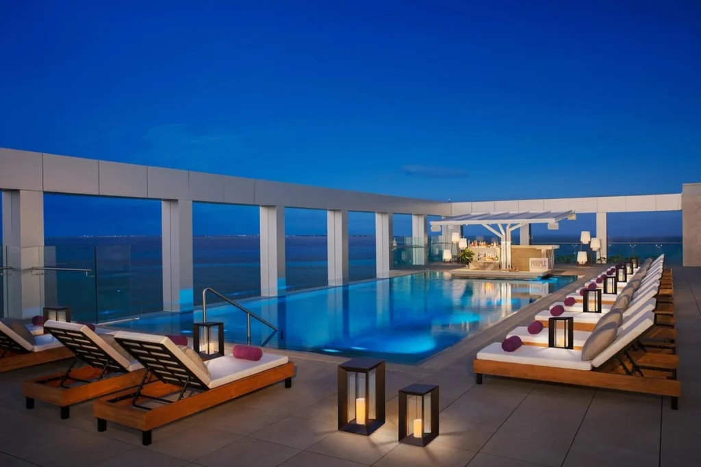 Rooftop swimming pool with ocean views, loungers and an illuminated poolside bar, Breathless Cancun Soul Resort & Spa