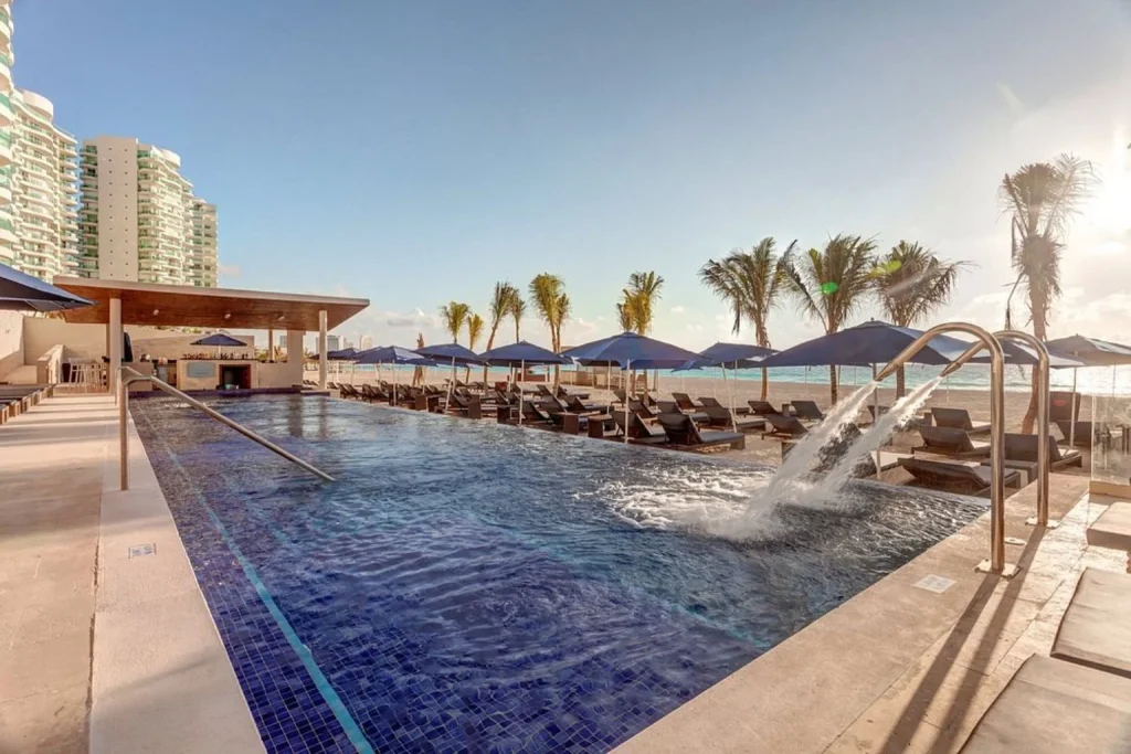 Pool with water features and sea view at Royalton CHIC Cancun