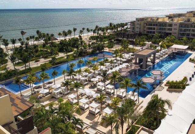 Aerial view of the oceanfront pool and beachfront at Royalton Riviera Cancún