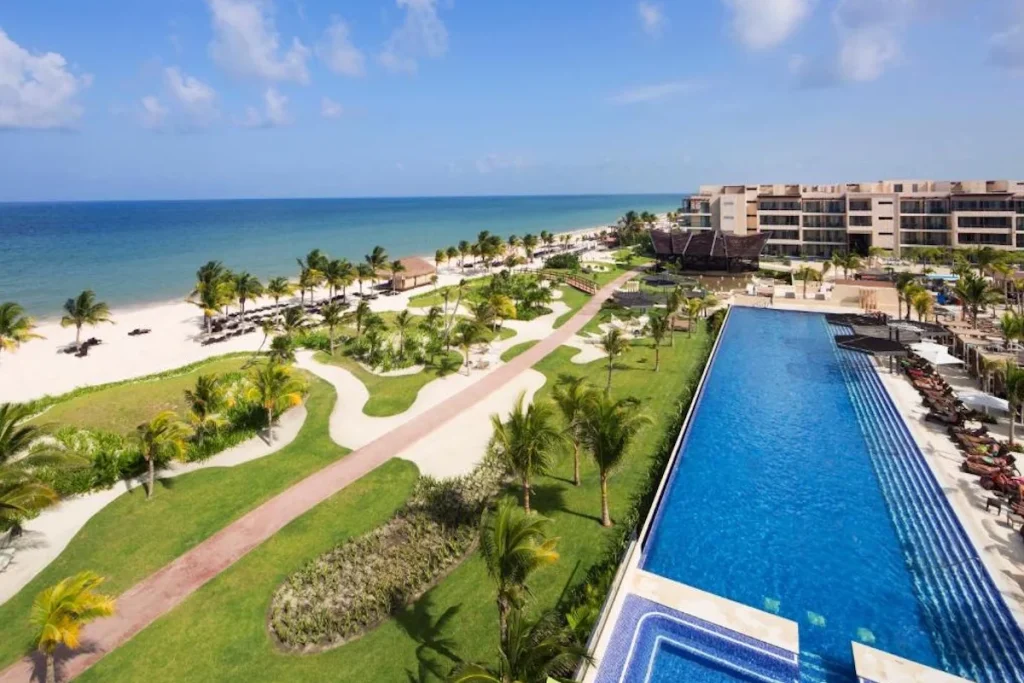 Oceanfront infinity pool and white sand beach at Royalton Riviera Cancún