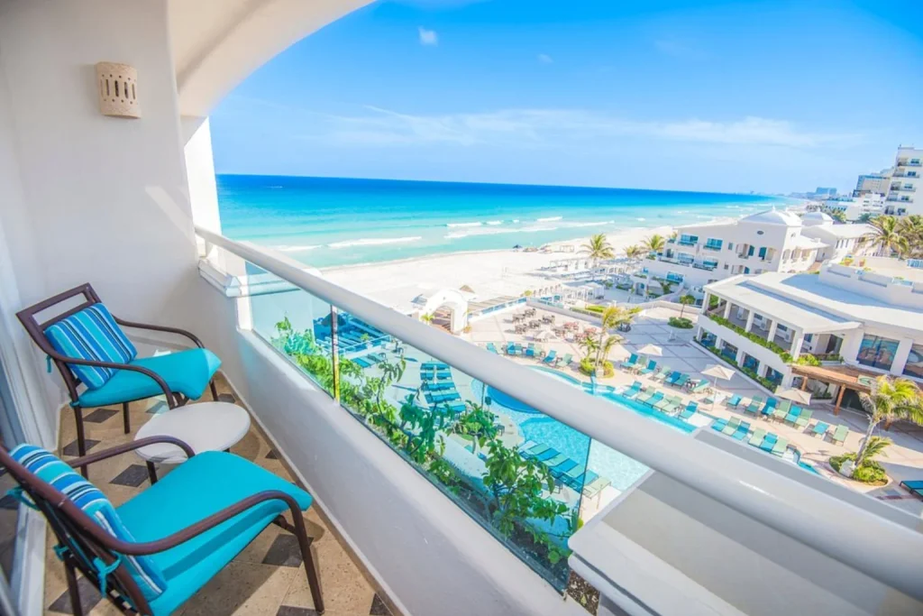Balcony overlooking the resort pool, sandy beach and Caribbean Sea at Sunscape Cancun Resort & Spa in Cancun