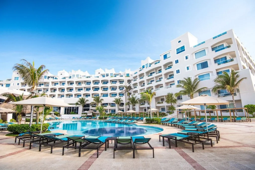 Main outdoor swimming pool with sun loungers at Sunscape Cancun Resort & Spa in Cancún, Mexico.