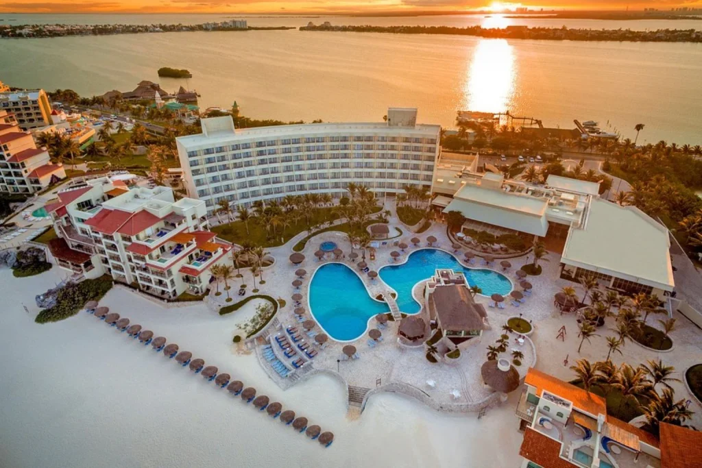 Resort pools and tropical grounds overlooking the lagoon at sunset, Grand Park Royal Cancun, Cancun