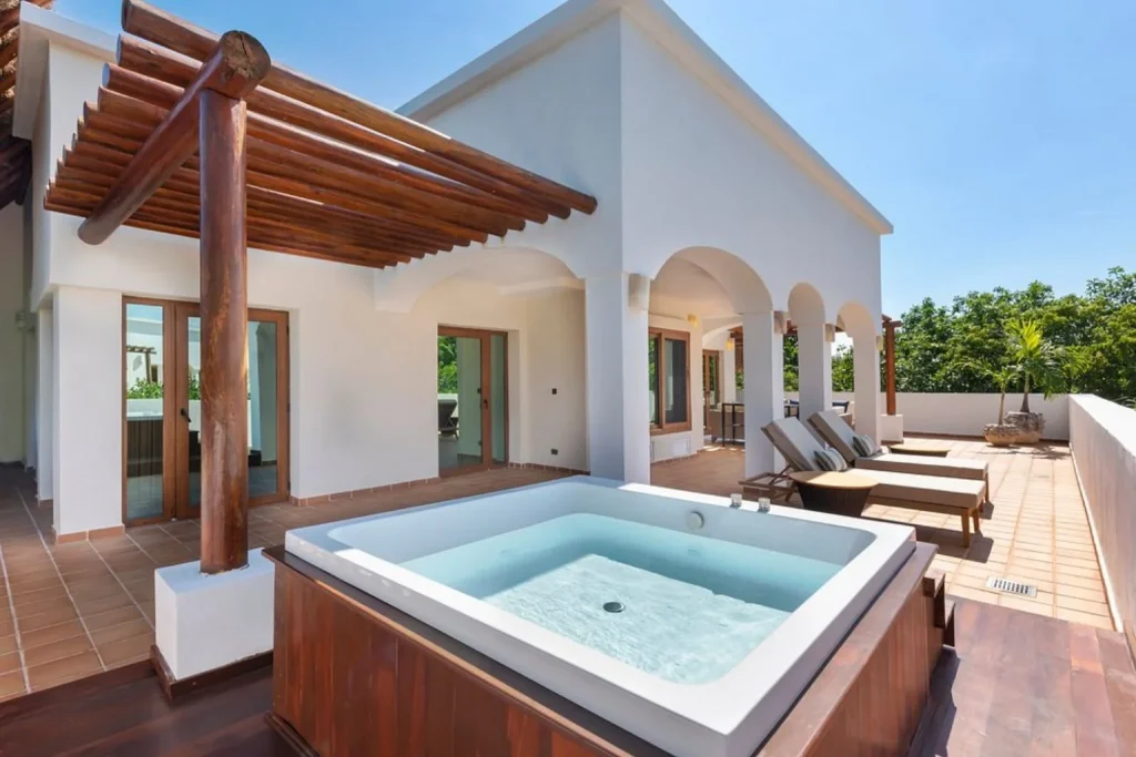 Private suite terrace with an outdoor jacuzzi and sun loungers at Valentin Imperial Riviera Maya, near Cancun, Mexico.