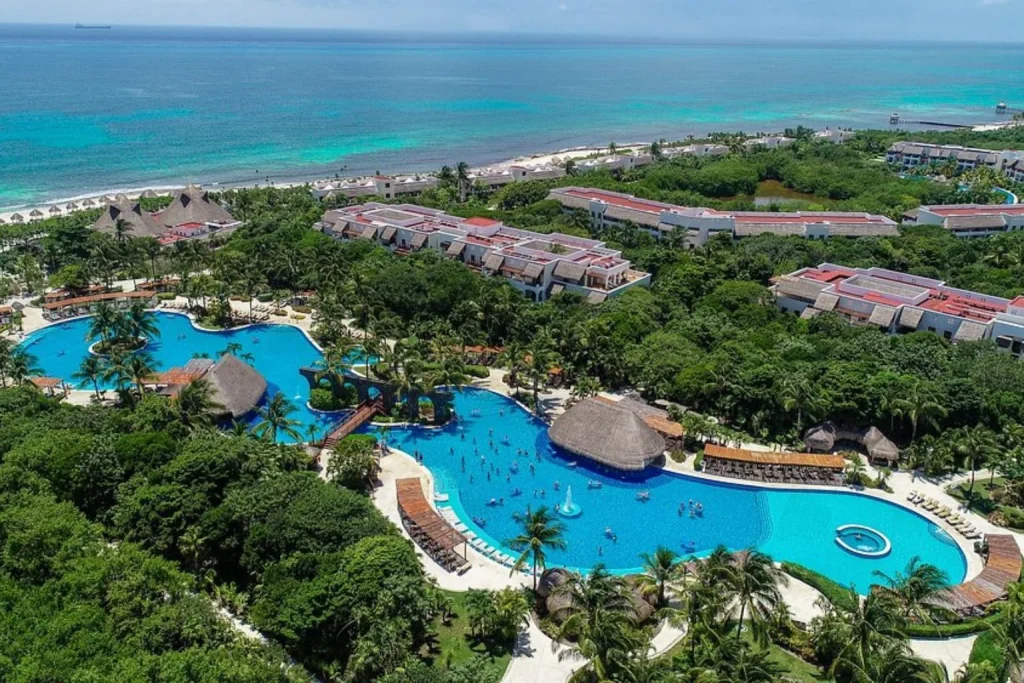Resort pools surrounded by tropical gardens at Valentin Imperial Riviera Maya.