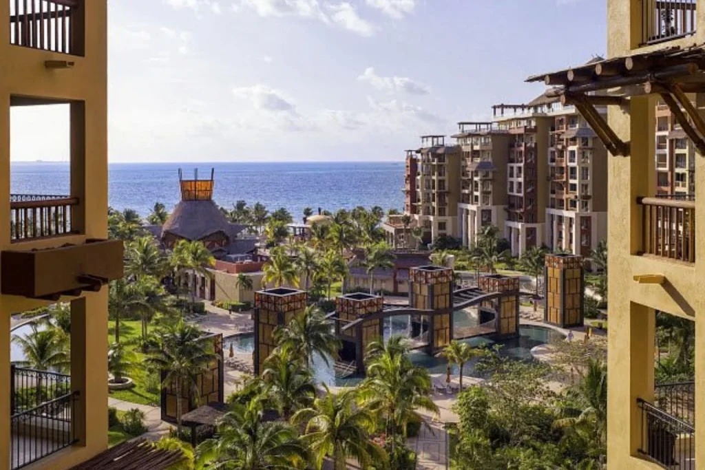 Aerial view of Villa del Palmar Cancun featuring tropical gardens, resort buildings, decorative pools, and the Caribbean Sea in Cancun, Mexico.
